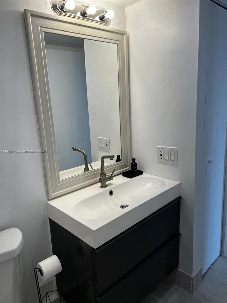 4164 Inverrary Drive, Unit 510 Lauderhill, FL 33319 - Photo 14 of 21 a bathroom with a sink vanity and toilet