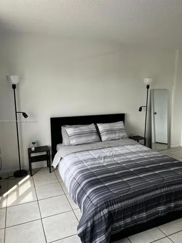 a bedroom with a bed and a cabinets