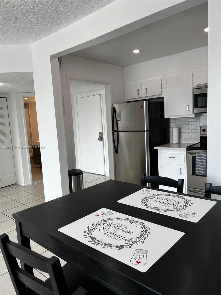 4164 Inverrary Drive, Unit 510 Lauderhill, FL 33319 - Photo 2 of 21 a kitchen with a refrigerator and a stove top oven