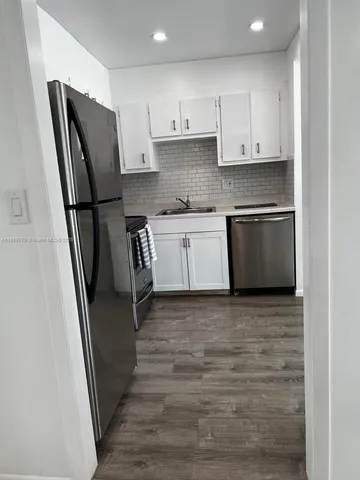a white refrigerator freezer sitting inside of a kitchen