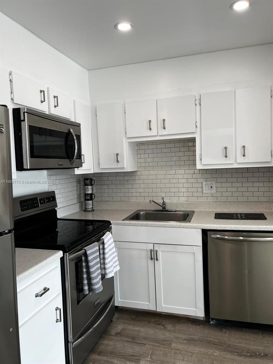 4164 Inverrary Drive, Unit 510 Lauderhill, FL 33319 - Photo 7 of 21 a kitchen with cabinets stainless steel appliances and a sink