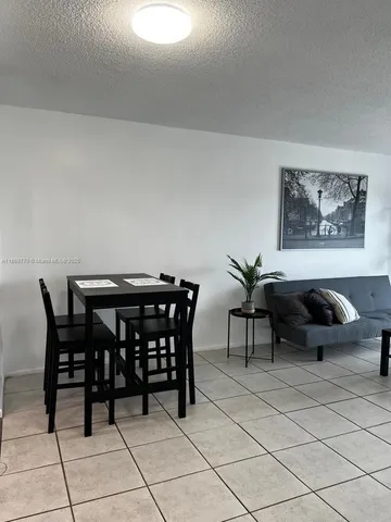 a view of a dining table and chairs in a room