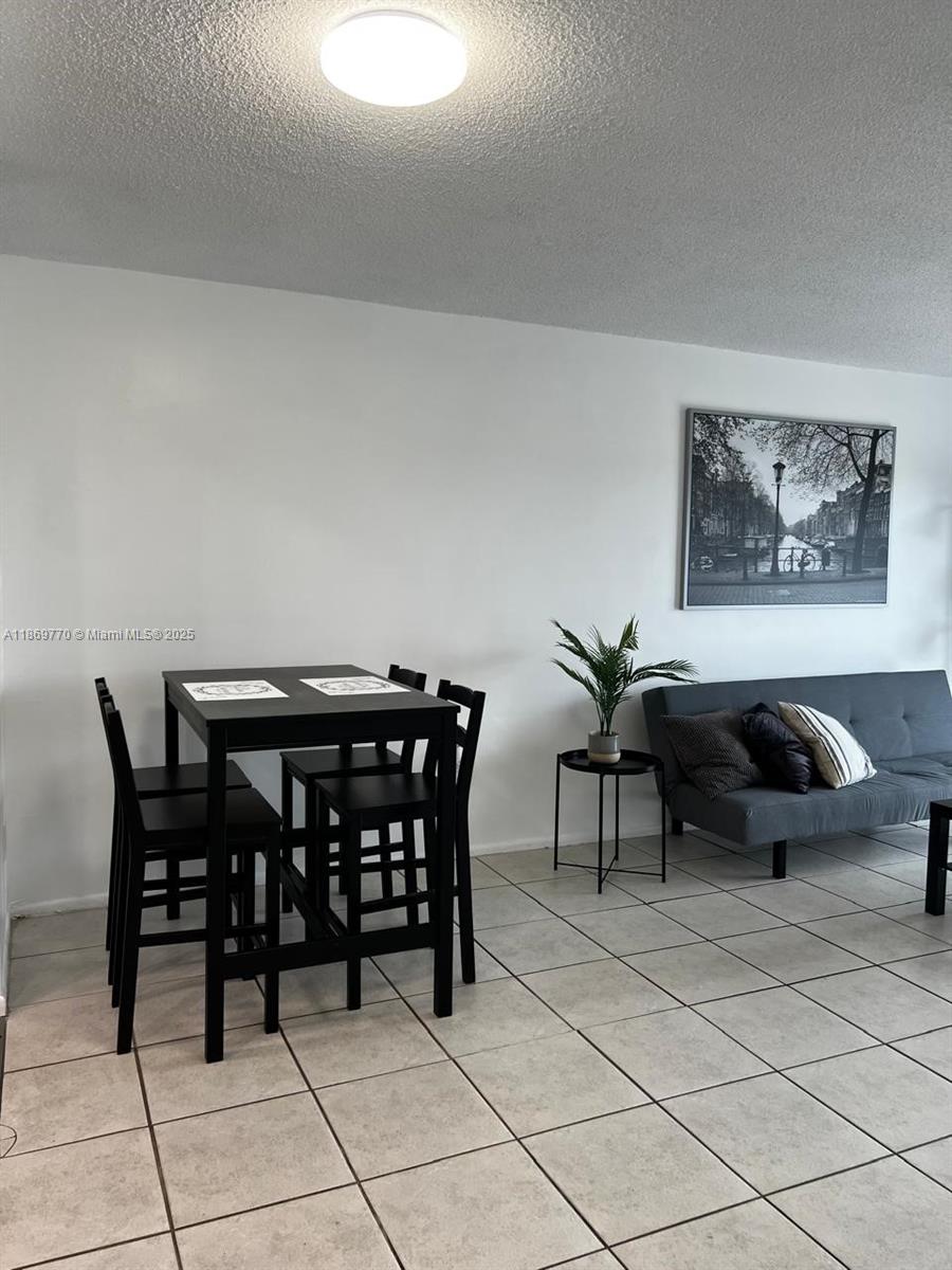4164 Inverrary Drive, Unit 510 Lauderhill, FL 33319 - Photo 8 of 21 a view of a dining table and chairs in a room