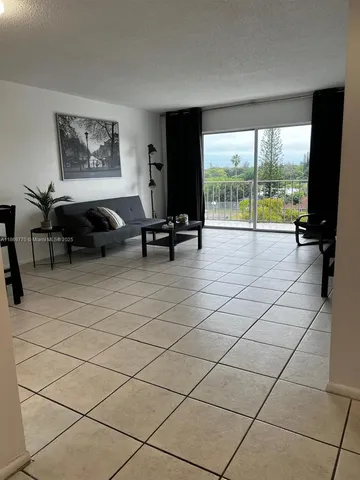 a living room with furniture and large windows