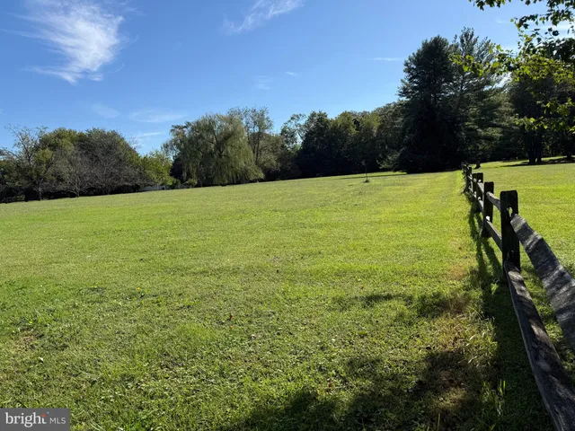 a view of field with trees in the background