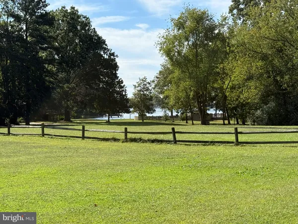 a view of outdoor space with green field and trees