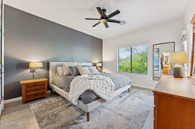 a bedroom with a bed and a large window