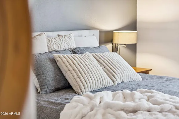 a bedroom with a bed and a night stand