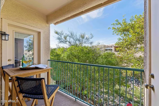 a balcony with table and chairs