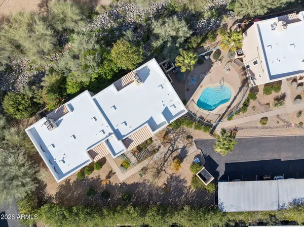 an aerial view of a house with a yard and parking spaces