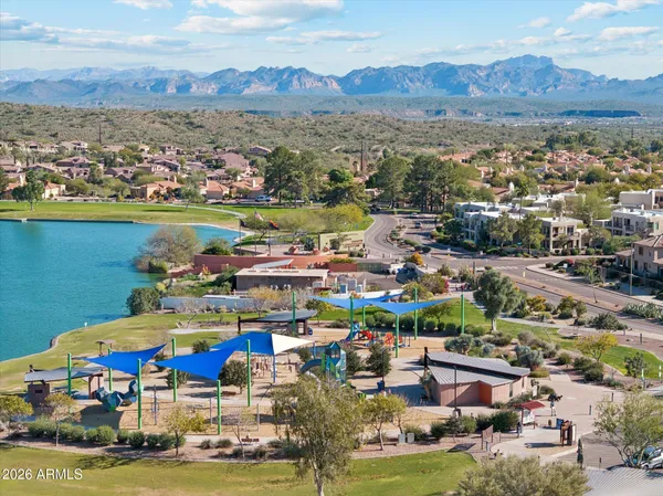 an aerial view of residential building and lake