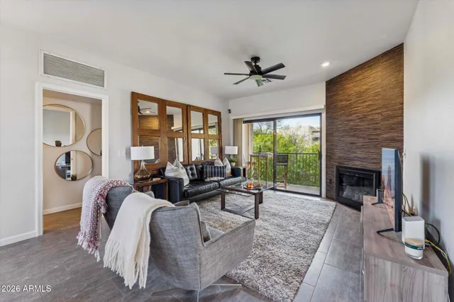 a living room with furniture large window and a fireplace