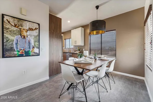 a view of a dining room with furniture and chandelier