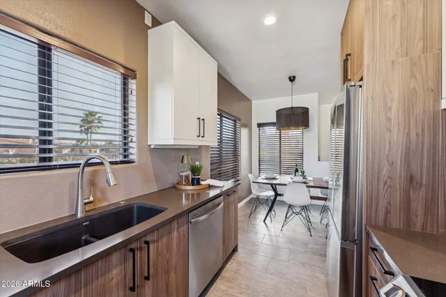 a kitchen with sink refrigerator and cabinets