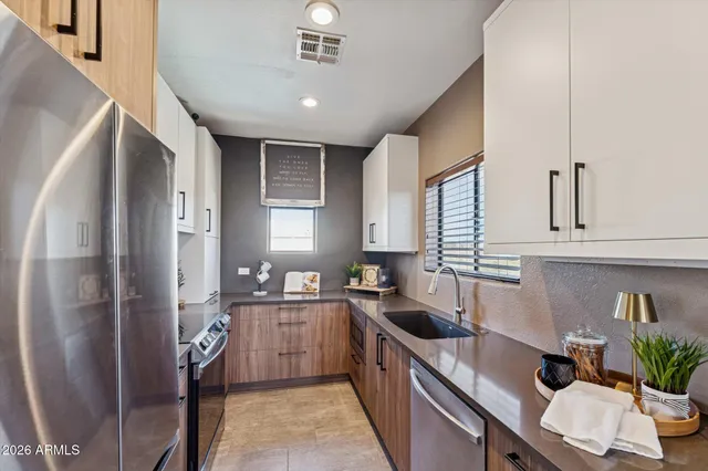 a kitchen with a sink refrigerator and cabinets