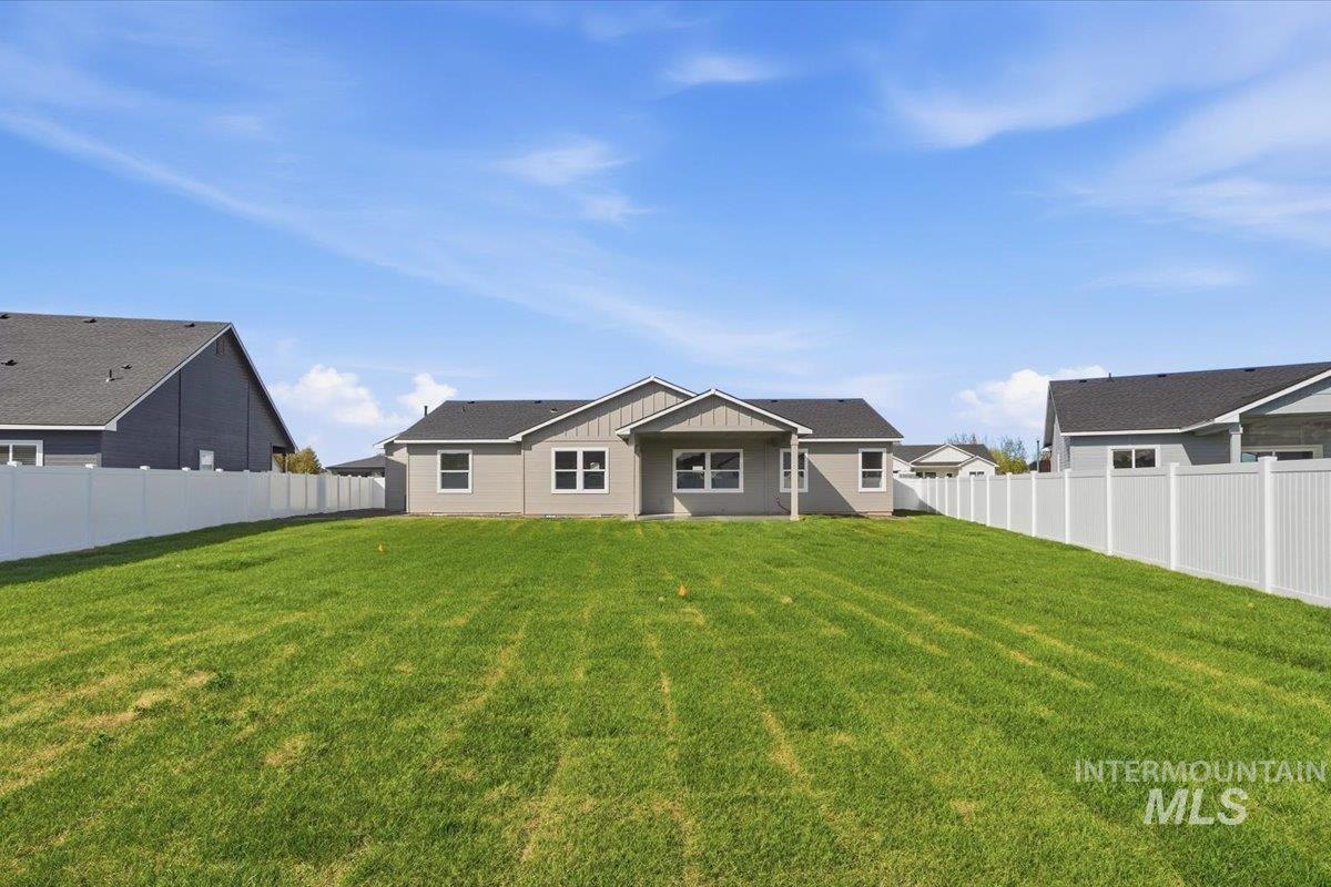 2175 Austin Way Fruitland, ID 83619 - Photo 29 of 30 Back of property with a fenced backyard and a patio
