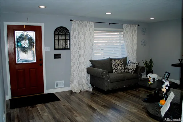 a dining room with furniture and wooden floor