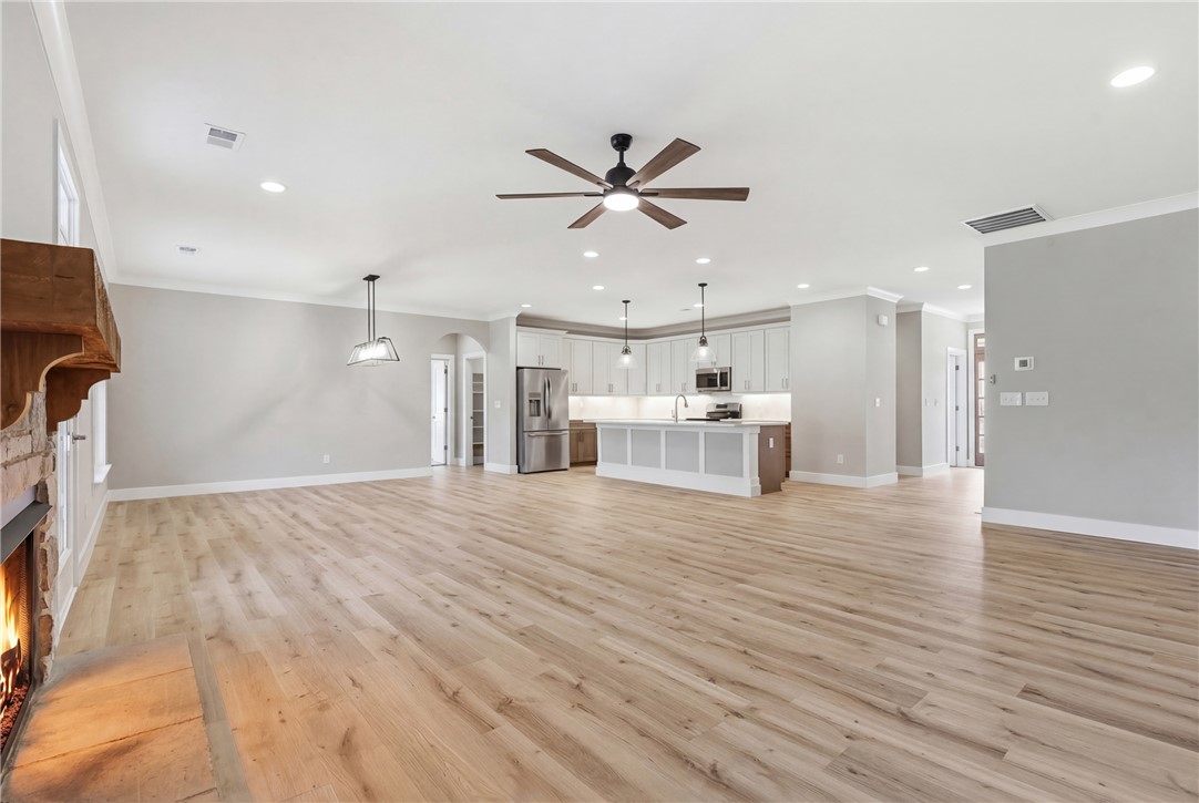 736 Stewart Gin Road Liberty, SC 29657 - Photo 7 of 50 An inviting open-concept living space features light wood flooring, a fireplace, and a modern kitchen.