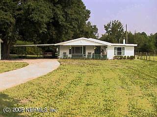 3565 Snyder Road Callahan, FL 32011 - Photo 1 of 1 a white house with a large pool