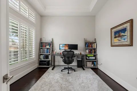 a view of a workspace with furniture and a window