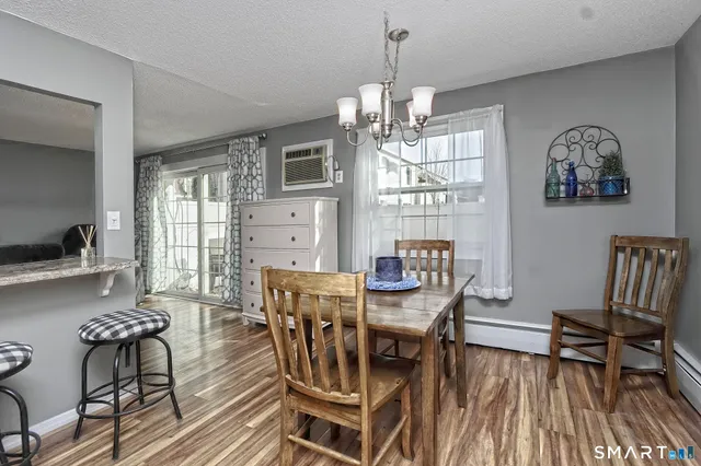 a view of a dining room with furniture window and wooden floor