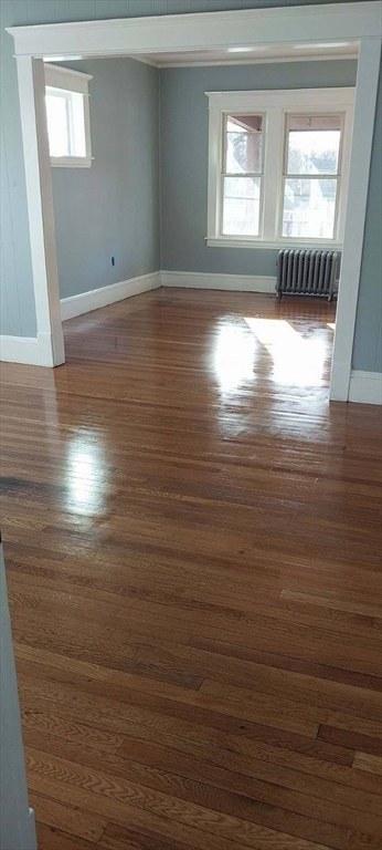 53 Foster Street Springfield, MA 01105 - Photo 1 of 11 a view of empty room with window and wooden floor