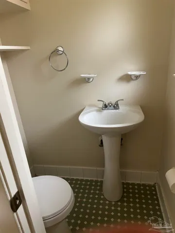 a bathroom with a sink toilet and a mirror