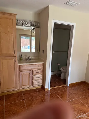 a bathroom with a sink a toilet and a mirror