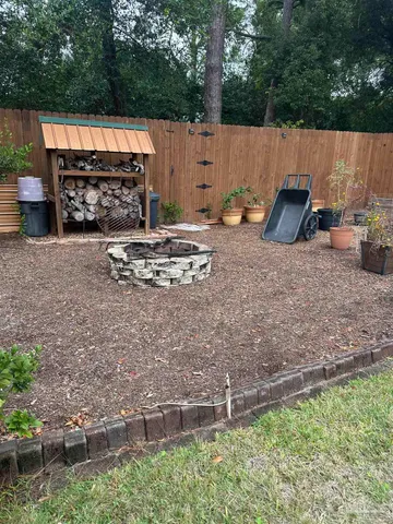 a backyard of a house with table and chairs