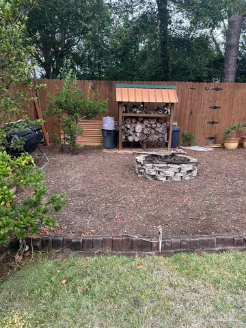 a view of a backyard with plants and outdoor seating