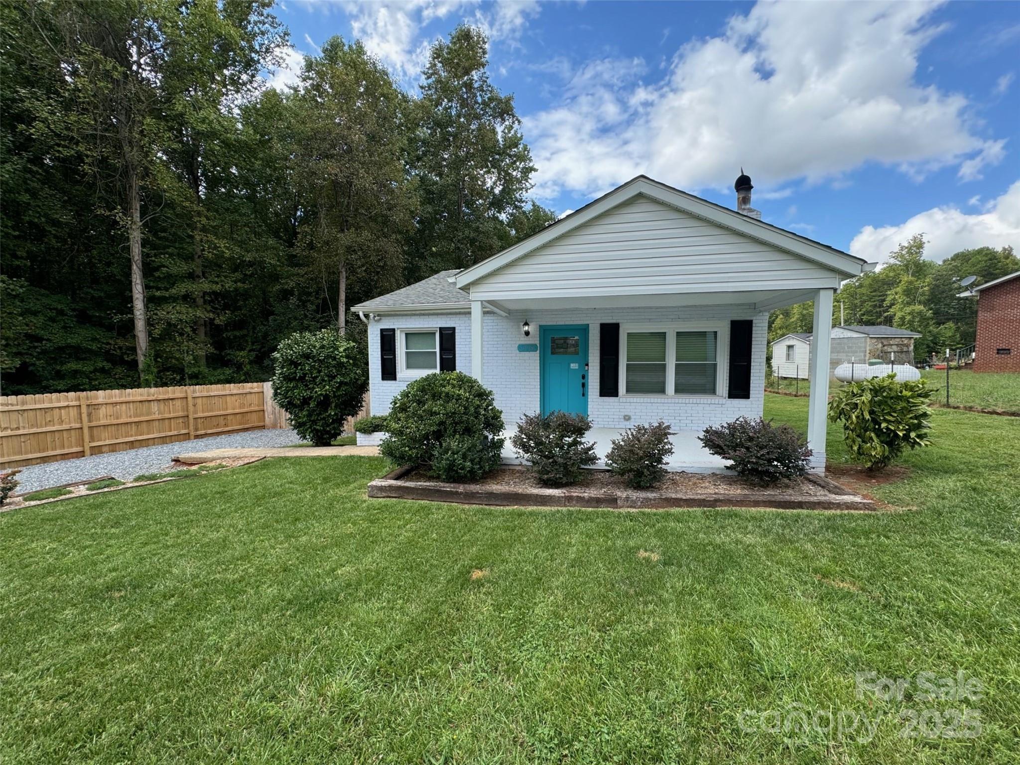 a front view of house with yard and green space