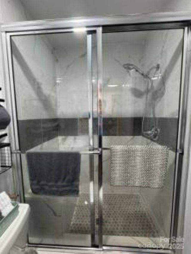 318 Lake Montonia Road Kings Mountain, NC 28086 - Photo 14 of 23 a bathroom with a glass shower door