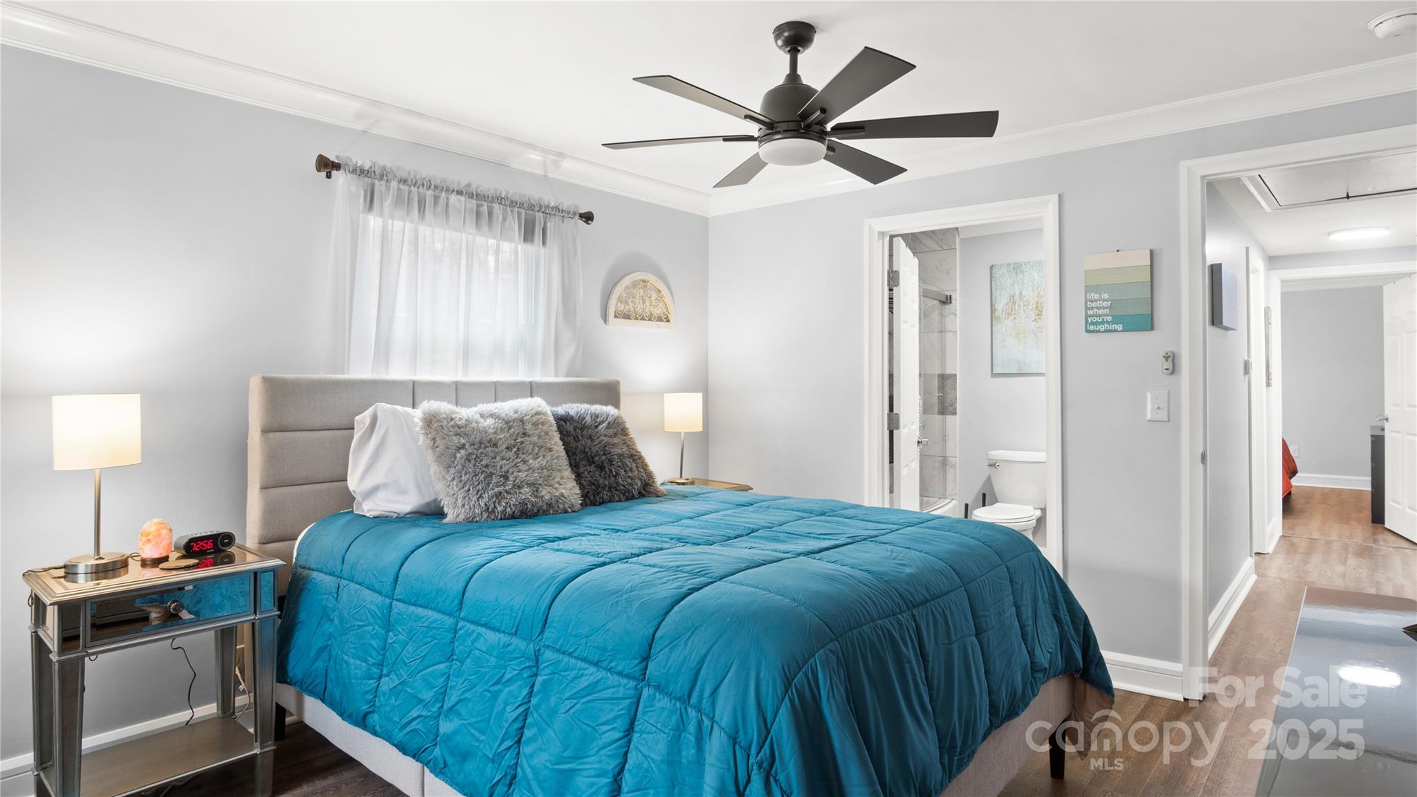 318 Lake Montonia Road Kings Mountain, NC 28086 - Photo 7 of 23 a bedroom with a large bed and a chandelier