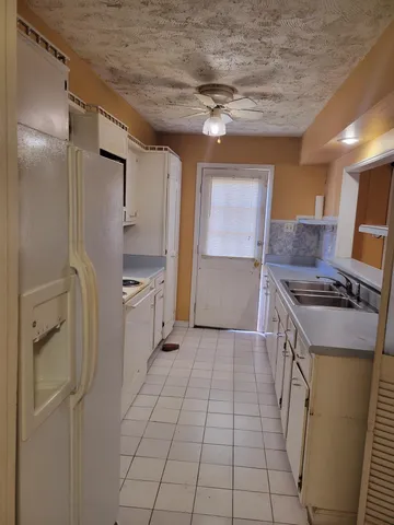 a kitchen with a stove and a refrigerator