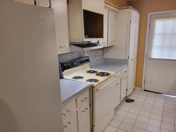 a kitchen with a sink a stove and cabinets
