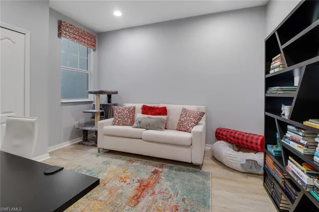 a living room with a couch and a book shelf