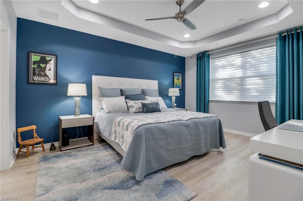 6973 Avalon Circle, Unit 1403 Naples, FL 34112 - Photo 15 of 37 Bedroom featuring a raised ceiling, light wood finished floors, ceiling fan, and recessed lighting
