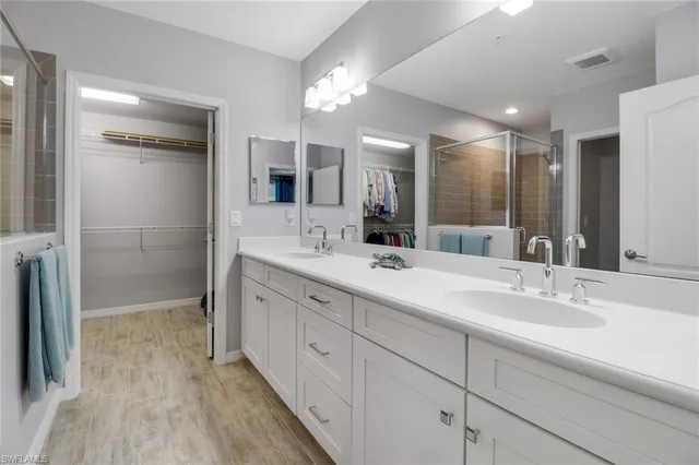 a bathroom with double vanity sink and a mirror