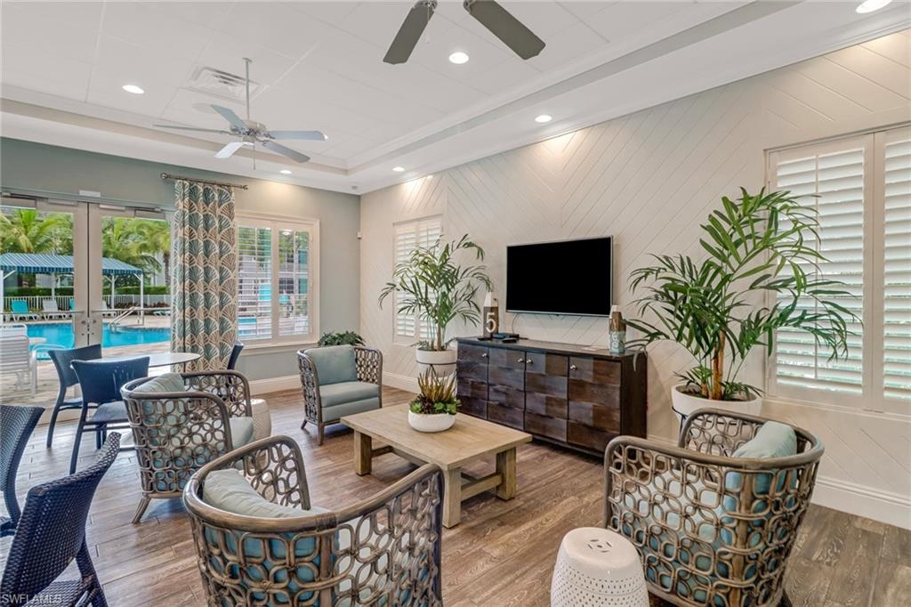 6973 Avalon Circle, Unit 1403 Naples, FL 34112 - Photo 27 of 37 Living area featuring wood finished floors, french doors, recessed lighting, wooden walls, and ceiling fan