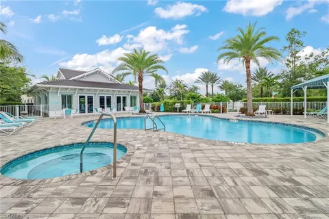 a view of a house with swimming pool and sitting area