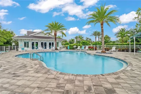 a view of a swimming pool with a table and chairs