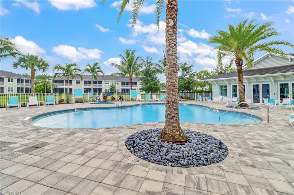 6973 Avalon Circle, Unit 1403 Naples, FL 34112 - Photo 33 of 37 Community pool featuring a patio and french doors