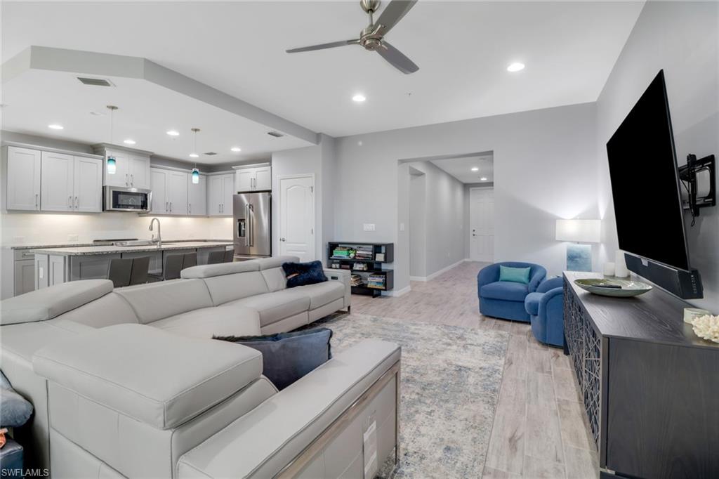 6973 Avalon Circle, Unit 1403 Naples, FL 34112 - Photo 7 of 37 Living room featuring light wood-style floors, recessed lighting, and a ceiling fan