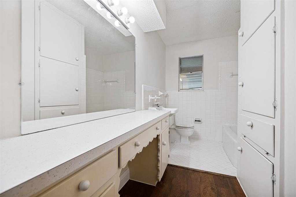 5319 Urban Crest Road Dallas, TX 75227 - Photo 12 of 21 Bathroom featuring a vanity with an elongated countertop and a full-width mirror
