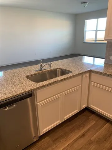 an empty room with wooden floor and closet