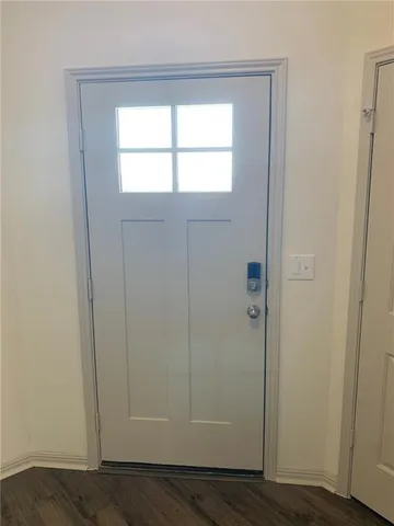 a white toilet sitting next to a white wall