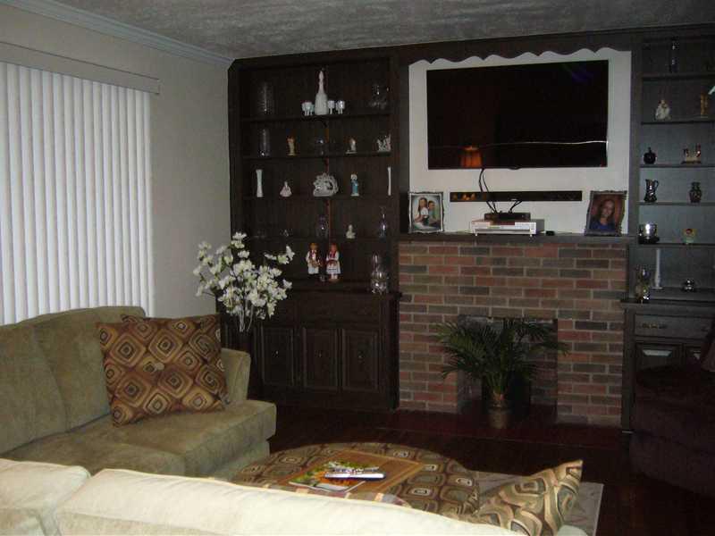 1214 Ridgeway Avenue Aliquippa, PA 15001 - Photo 2 of 17 Living Room. Beautiful living room, with original wood built-ins, a decorative fireplace, and the original hardwood floors.