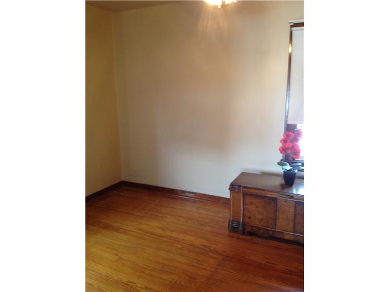 1214 Ridgeway Avenue Aliquippa, PA 15001 - Photo 13 of 17 Bedroom. Original hardwood throughout home. This is third of three bedrooms.
