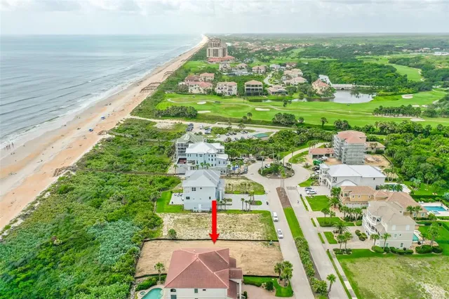 an aerial view of residential houses with outdoor space and swimming pool