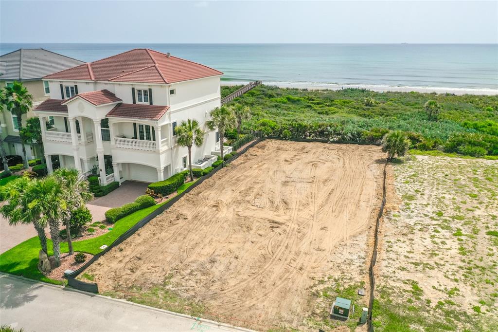 29 Ocean Ridge Boulevard Palm Coast, FL 32137 - Photo 4 of 51 a view of a white house with a yard and potted plants
